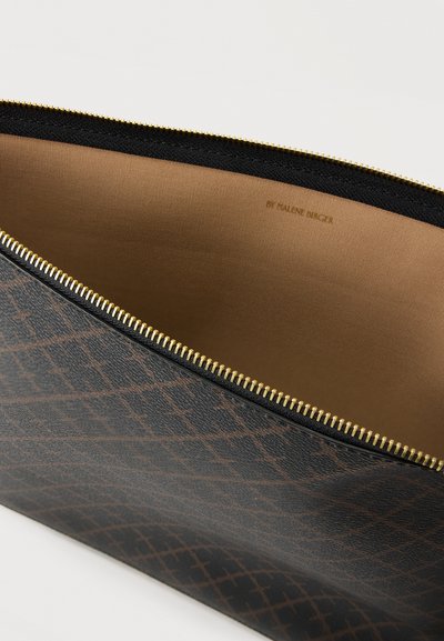 Καφέ και μαύρο τσαντάκι με φερμουάρ και σχέδιο, μερικώς ανοιχτό, που δείχνει την ταμπά εσωτερική επένδυση και τα χρυσά δόντια του φερμουάρ.