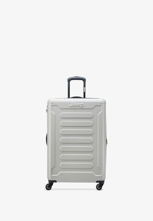 Silver hard-shell suitcase with extendable black handle and four black spinner wheels, branded with Jeep logo on front and handle.