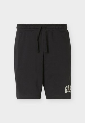 Shorts noirs à taille élastique avec un cordon de serrage et le logo "GAP" imprimé près de l'ourlet gauche, présentés sur un fond uni clair.
