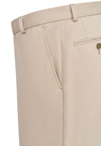 Beige dress pants with a smooth texture, featuring front pockets, a subtle sheen, and a single back pocket with a brown button.