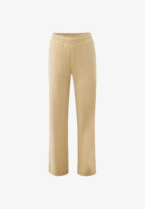 Pantalones de chándal beige de pierna recta con cintura elástica y bolsillos laterales, mostrados sobre un fondo blanco.