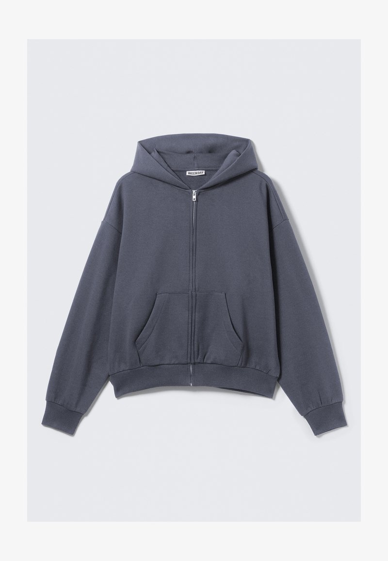 Hoodie zippé gris en mélange de coton doux, doté d'une grande poche avant, de poignets côtelés et d'une grande capuche. Design minimaliste.