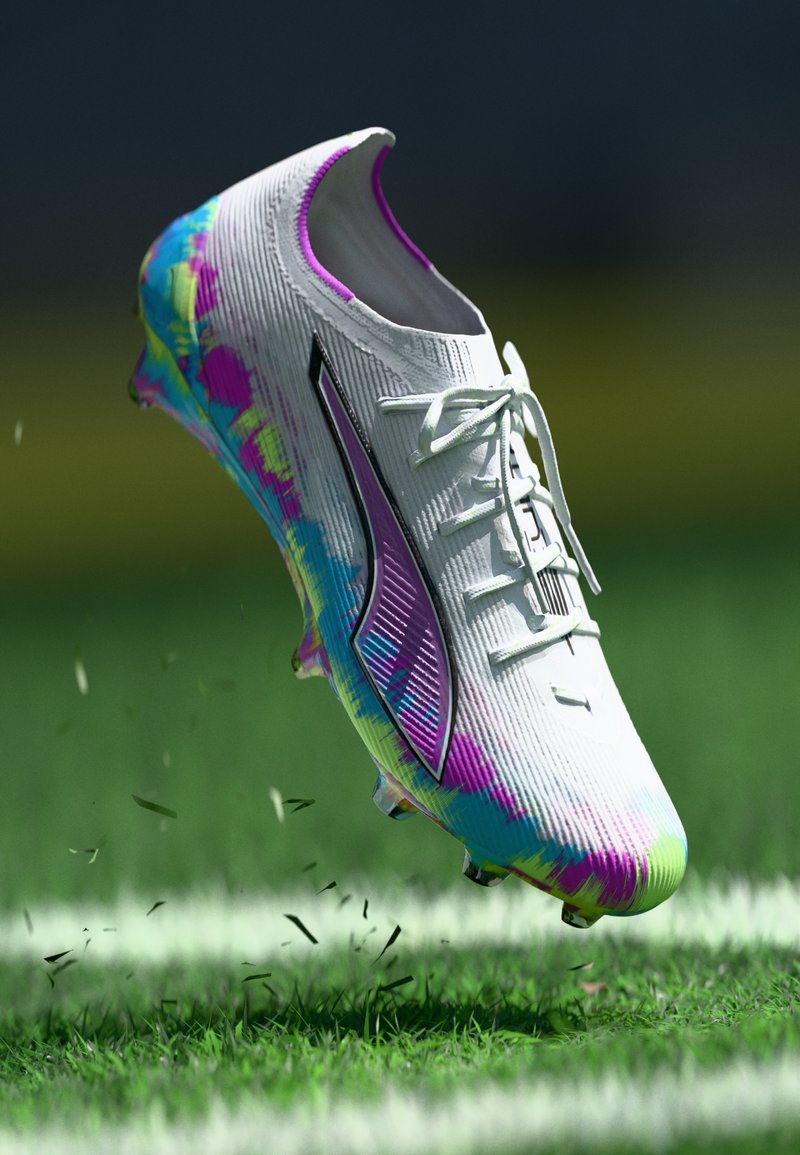 Soccer cleat with a white upper featuring vibrant blue, pink, and green accents, textured surface, and black logo detail. Clear studs on sole.