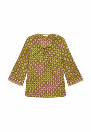 Top giallo a maniche lunghe con motivi circolari viola, scollo con laccetto e polsini decorati con conchiglie bianche e frange.