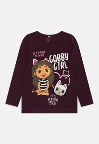 Ljubičasta košulja dugih rukava od pamuka s crtanim motivom djevojke s kovrčavom kosom i mačkom, tekst glasi "Gabby Girl" i "It's Meow Time!"
