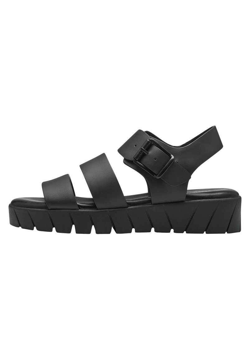 Black sandal with three wide straps and a side buckle. Features a thick, ridged sole with a textured pattern for grip and support.