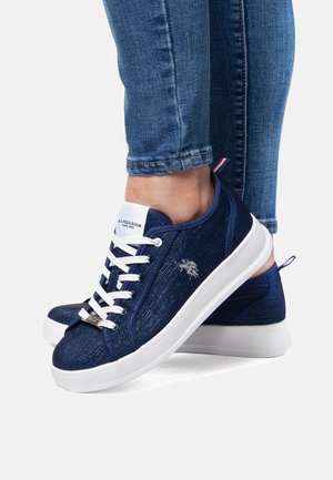 Navy blue sneakers made from textured fabric, featuring white laces, a white sole, and a small logo detail on the side.