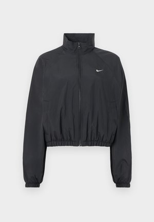 Black cropped jacket made of lightweight, smooth fabric. Features a high collar, full zipper, and elastic cuffs with a white logo detail.