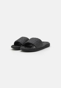 Black slide sandals with a textured upper featuring a diamond pattern, open toe design, and cushioned sole for comfort.