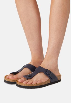 Marine flip-flops met een gladde band en verstelbare gesp, voorzien van een kurken voetbed en een gestructureerde rubberen buitenzool.