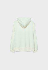 Sweat à capuche couleur crème avec une texture douce, coupe ample et capuche à cordon de serrage. Doté de poignets et d'un ourlet côtelés, avec un design minimaliste.