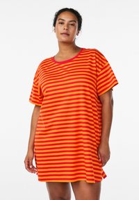 Striped short-sleeve t-shirt dress in red and yellow, featuring a round neckline and side slits for ease of movement. Soft fabric texture.