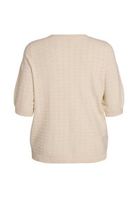 Suéter de punto color crema con mangas cortas estilo globo. Presenta un patrón texturizado en toda la prenda y un escote redondeado. Corte holgado.