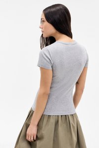 Gray, fitted t-shirt with short sleeves, crew neck, and smooth texture, worn with a voluminous olive green skirt. No notable patterns or accents.