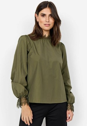 Olive green blouse with puff sleeves, lace trim at cuffs, and a high neckline. Smooth fabric with a relaxed fit.