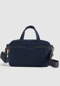 Denim bag with a dark blue color, rectangular shape, dual top handles, adjustable strap, and subtle stitching detail across the front.