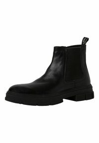 Černé kožené Chelsea boots s elastickými bočními panely, textura podešve a poutko. Mají zaoblenou špičku a mohutný profil.