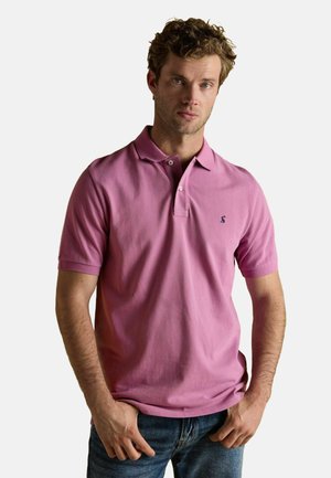 Short-sleeve polo shirt in bright pink cotton, featuring a collared neck, two-button placket, and small logo on the left chest.