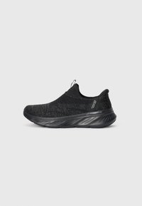 Black slip-on sneaker with a knitted upper and textured finish. Features a cushioned sole with a curved shape and pull tab at the back.