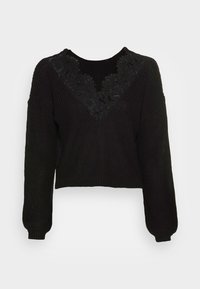 Sort strikket cropped sweater med lange ærmer, der har en blonde V-hals-design og ribbede manchetter og kant. Struktureret stof med en tætsiddende pasform.