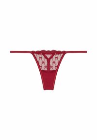 Tanga de encaje rojo con bordes festoneados, que presenta una tela transparente y un patrón decorativo de lazos. Tirantes laterales finos y parte trasera forrada.