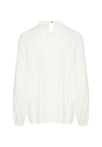 Blusa bianca a maniche lunghe con apertura a chiave sul retro, polsini elasticizzati e una texture liscia. Design semplice e privo di decorazioni.