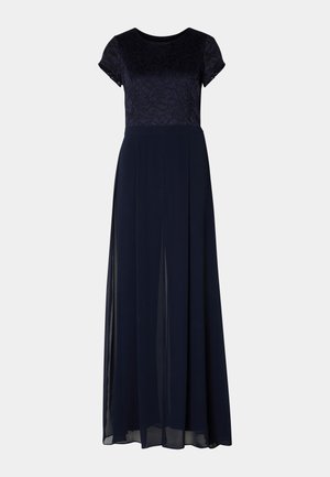 Navy blue evening dress with short lace sleeves, a fitted bodice, and a flowing skirt featuring side slits and a soft, sheer overlay.
