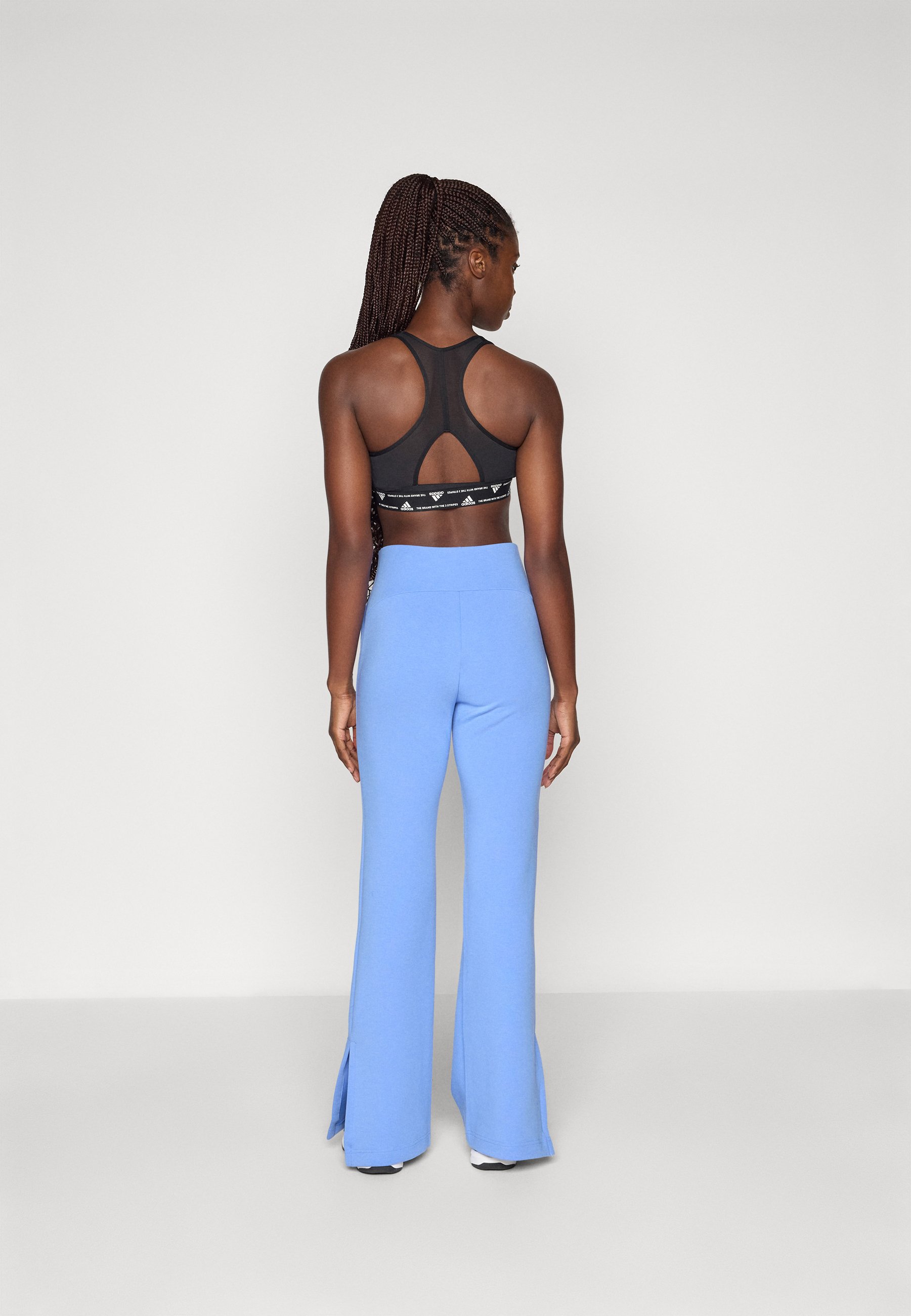 adidas Sportswear SOFT LUX FLARED PANTS - Tracksuit bottoms - blue