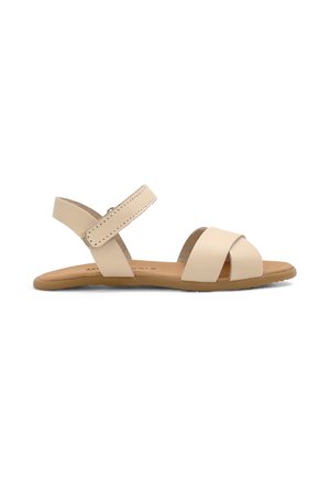 Sandalo piatto beige con due cinturini frontali, cinturino alla caviglia con chiusura a strappo e suola marrone, mostrato di lato.