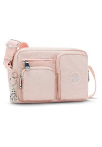 Jasnoróżowa nylonowa torba na ramię z wieloma kieszeniami na zamek, o prostokątnym kształcie, z odpinanym breloczkiem. Posiada regulowany pasek.