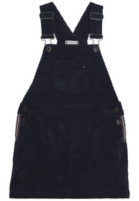 Námořnická manšestrová šatová sukně s nastavitelnými ramínky, přední kapsou a zapínáním na knoflíky po stranách s víceméně barevným pruhovaným detailem.