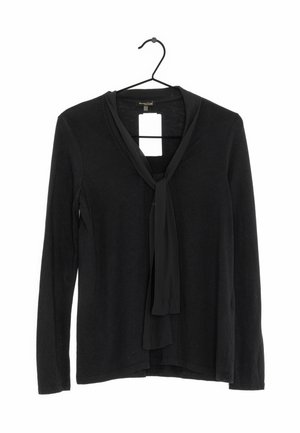 Black long-sleeve blouse with attached neck scarf, hanging on a black hanger, tag visible behind collar.