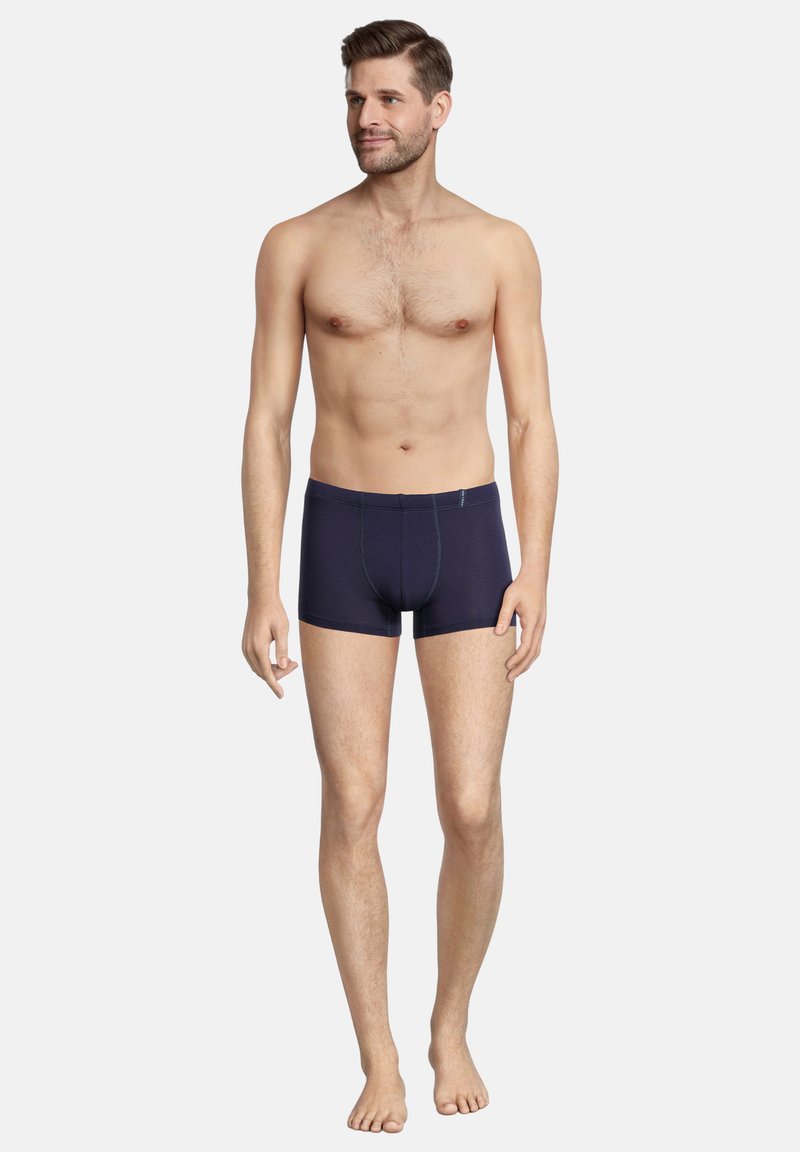 Navy blue cotton stretch boxer shorts with a fitted cut, featuring flatlock seams and a soft waistband. Smooth texture, no visible patterns.