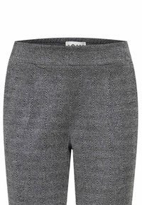 Houndstooth-muster schwarze und weiße Hose mit schmalem Bund, glattem Stoff und subtiler Textur. Maßgeschneidert für eine strukturierte Passform.