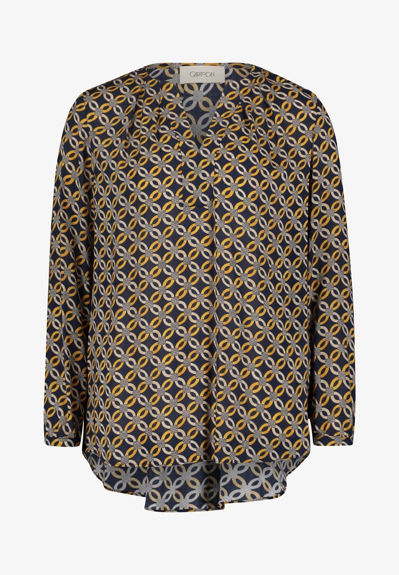 Granatowa bluzka z geometrycznym wzorem splecionych okręgów w kolorze żółtym, szarym i białym. Długie rękawy i dekolt w kształcie V.