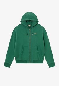 Felpa verde con zip, caratterizzata da un logo dorato, cappuccio con cordino, due tasche frontali e polsini e orlo a coste. Realizzata in tessuto morbido.