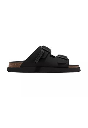 Sandalo nero a ciabatta con due cinturini regolabili con fibbia e soletta in sughero, vista laterale su sfondo bianco.