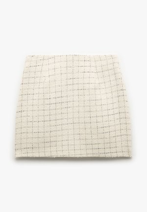 Woven cotton fabric in cream with a subtle grid pattern and a soft texture. Multi-toned threads add depth to the design.