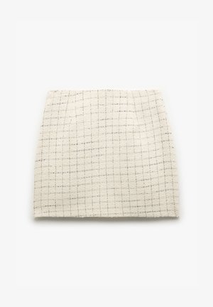 Woven cotton fabric in cream with a subtle grid pattern and a soft texture. Multi-toned threads add depth to the design.