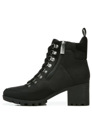 Black ankle boots with a textured surface, featuring a lace-up front, metallic eyelets, side zipper, and a chunky, grooved heel.