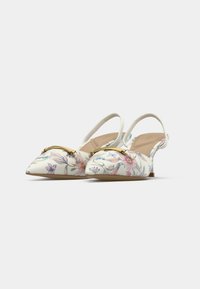 Chaussures slingback à motif floral avec un bout pointu, ornées d'un accent doré et d'une tige en textile de couleur claire. Talon bloc bas.