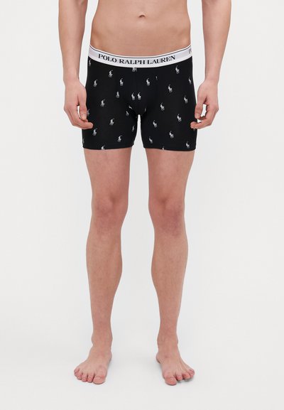 Zwarte boxershorts gemaakt van zachte materialen met een witte tailleband met het merk "POLO RALPH LAUREN" en kleine geborduurde paardenlogo's verspreid over de stof.