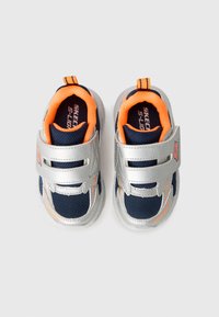 Silver and navy athletic shoes with orange accents, mesh upper, Velcro straps, and a padded collar. Features contrast stitching and logo detail.