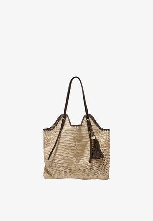Beige woven tote bag with dark brown leather handles, trim, and a tassel with shell decoration hanging on one side.