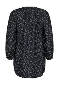 Blouse à motifs noirs à manches longues, en tissu léger et texturé, ornée d'un motif de losanges blancs répété. Encolure arrière froncée.