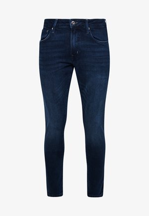 Slim-fit ciemnoniebieskie dżinsy z pięcioma kieszeniami, z logo na metalowych elementach i delikatnymi przetarciami. Gładka faktura, prosty krój nogawki.