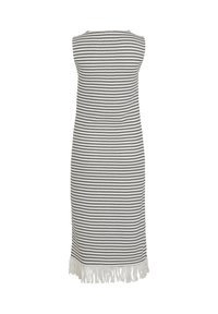 Robe sans manches longueur genou à rayures horizontales noires et blanches avec une bordure à franges blanches en bas.