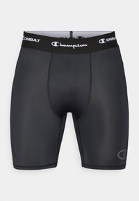 Zwarte atletische compressiekorte broeken van glad materiaal, met een elastische tailleband met bedrukt logo en contrasterende stikdetails.