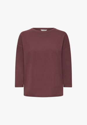 Bordo garās piedurknes krekls ar apaļu izgriezumu, brīvu piegriezumu un mīkstu tekstūru. Iezīmējas ar nolaistām plecu līnijām un taisnu apakšdaļu.