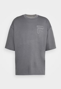 Camiseta gris de gran tamaño hecha de mezcla de algodón, con cuello redondo, mangas cortas y un logo bordado en blanco en el lado izquierdo del pecho.